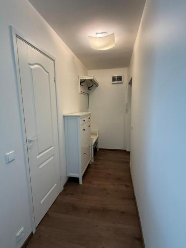 an empty hallway with a white door and a closet at Stay in Old Town in Võru