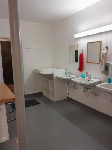 a bathroom with two sinks and two mirrors at Guesthouse in Ólafsvík