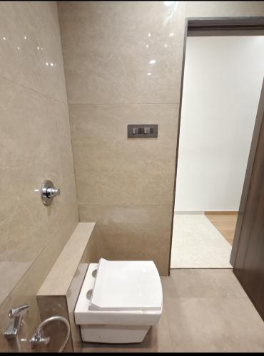 a bathroom with a toilet and a sink and a shower at Hotel Krishiv- Sanand in Sānand