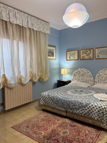 a bedroom with blue walls and a bed with a rug at La Casa al Sole in Mazara del Vallo