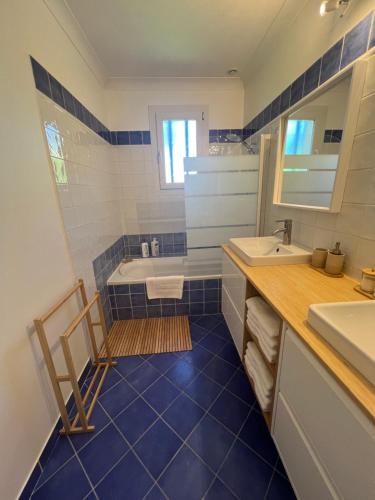 a bathroom with a blue tile floor and a tub and sink at La Maison d'Orange - Au calme à 2 pas du Théâtre Antique in Orange