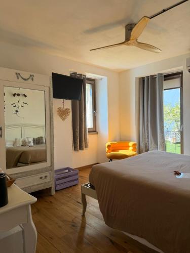 a bedroom with a bed and a dresser and a mirror at Il posto al sole in Teglio