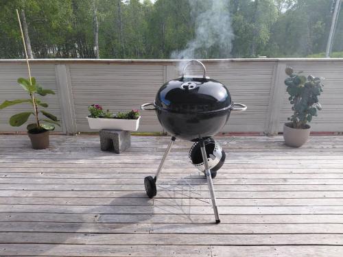 a grill sitting on a stand on a patio at Artic home komfort in Tromsø