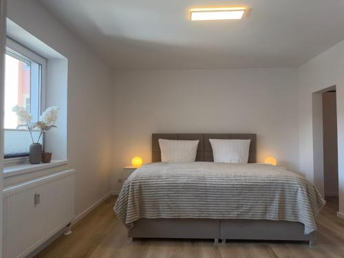 a bedroom with a bed with two pillows and a window at APARTMENT in Hambach in Hambach