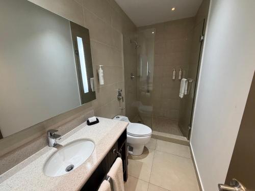 a bathroom with a sink and a toilet and a shower at The District Hotel in Panama City