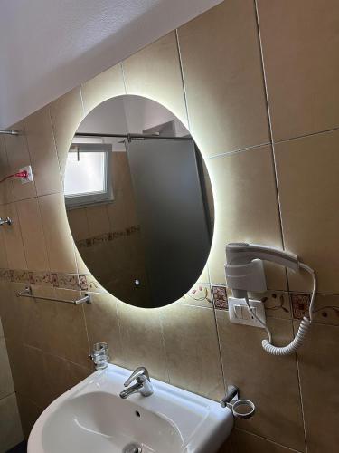 a bathroom with a mirror and a sink at Villa Del Sol in Golem
