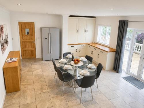 a kitchen with a table and chairs and a refrigerator at Number 15 in Norwich