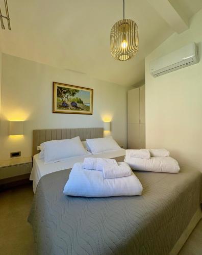 a bedroom with two beds with white pillows at Brand new Big Blue in Jelsa