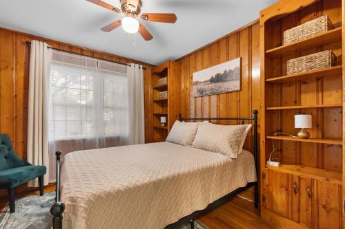 a bedroom with a bed and a ceiling fan at The Brick House Georgetown in Georgetown