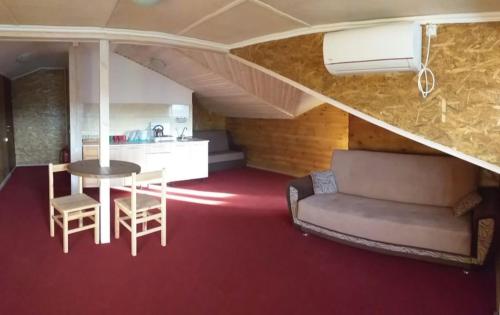 a living room with a couch and a table at Апартаменти Аліканте in Zatoka