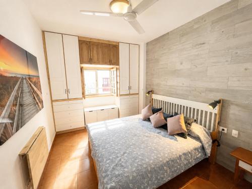a bedroom with a bed with pillows on it at candelaria Quiet 2bedroom Apartment near the Sea FAST WIFI FAST WIFI in Candelaria