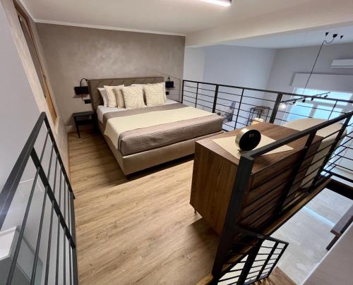 a large bedroom with a bed and a balcony at Loft43 in Trani