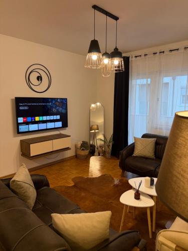 a living room with a couch and a flat screen tv at Premium Apartment in Peje