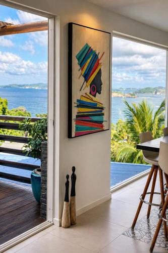 a room with a sliding glass door with a view of the ocean at Résidence Nakiya in Sainte-Marie