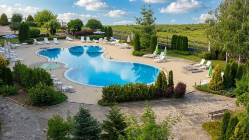 an overhead view of a swimming pool with chairs and umbrellas at Edelweiss Studio - Aspen Valley in Razlog