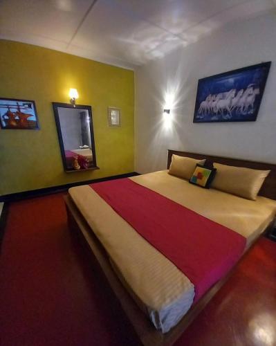 a bedroom with a large bed in a room at Amith Villa in Koggala