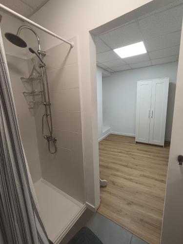 a room with a walk in shower and a hallway at Casa Ameghino in Laujar de Andarax