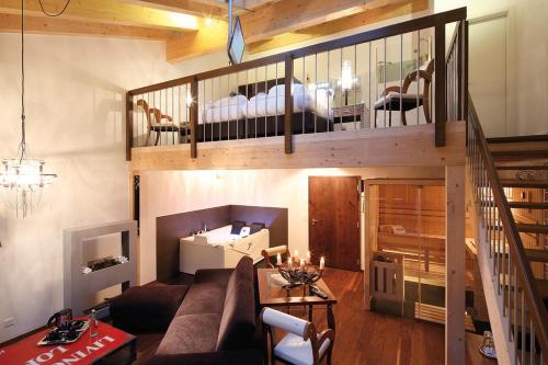 - un salon avec un canapé et un escalier dans l'établissement Loftsuite Hotel Saas, à Saas-Almagell