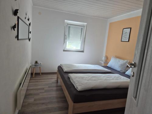a bedroom with two beds and a window at Auszeit in Balatonmagyaród