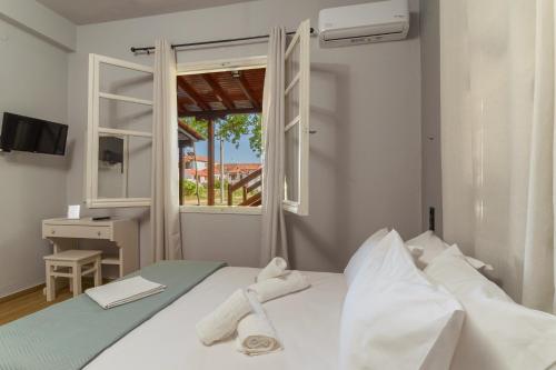 a bedroom with a bed with towels on it at Eudokia's House Platanias in Platanias