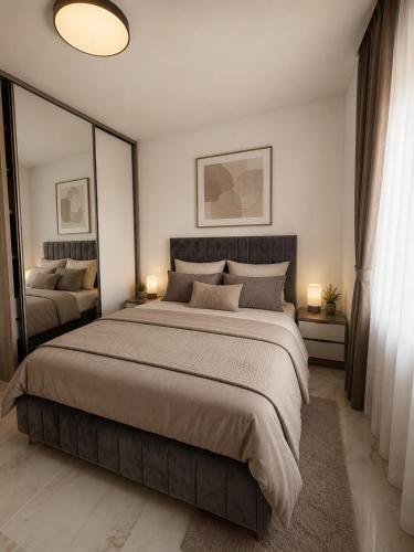 a bedroom with a large bed and two lamps at Visnjeva Gardens in Višnjevo