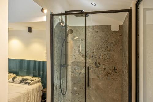 a shower with a glass door in a bedroom at Casa Campinchi in Bastia