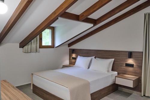a bedroom with a large white bed with a window at Villa Rock&SeaView in Livanates