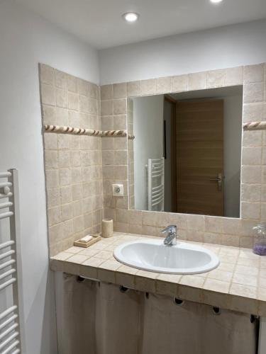 a bathroom with a sink and a mirror at la capelette in Céreste