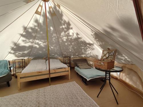 a room with a tent with a bed and a chair at Anniksson Glamping Telk- Loodustelk in Virtsu