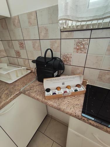 a box of donuts sitting on top of a counter at Foissner Apartments in Zavalatica