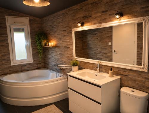 a bathroom with a tub and a sink and a toilet at Casa de campo en alava in Ollávarre