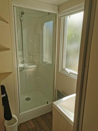 a bathroom with a shower and a sink at Camping du Pontis in Verteillac