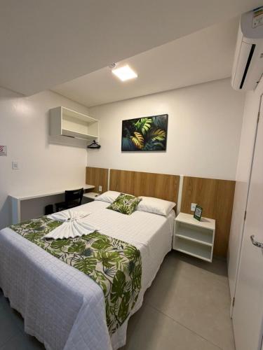 a bedroom with a bed and a picture on the wall at Priamo Hotel in Santo Antonio do Sudoeste