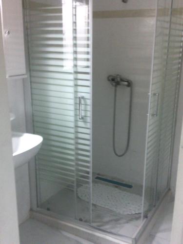 a shower with a glass enclosure in a bathroom at ΑΚ City Apartment 1 in Ágios Rókkos