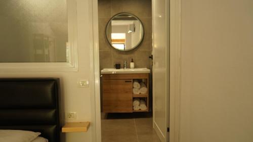 a bathroom with a sink and a mirror at Life on Green in Himare