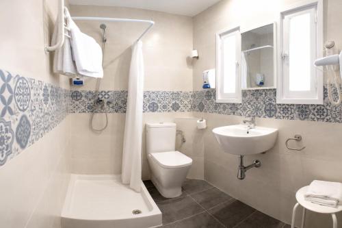 a bathroom with a toilet and a sink at L´Hostalet in Tossa de Mar