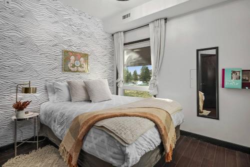 a bedroom with a bed and a window at Stunning Mountain Views - Pool&HotTub - King Bed - BBQ in Canmore