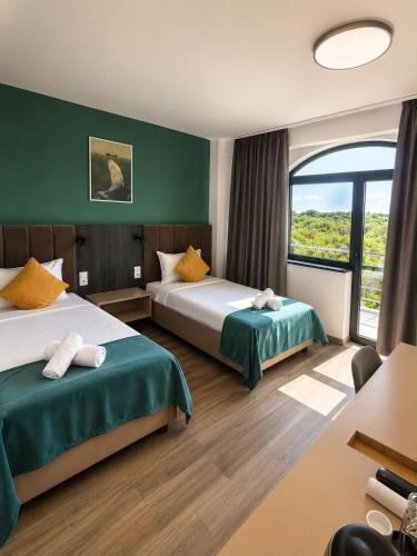 a hotel room with two beds and a window at Casa Acati Venus in Venus