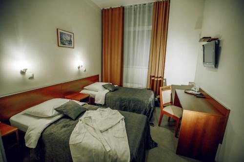 Un pat sau paturi într-o cameră la Hotel Novaya Krepost