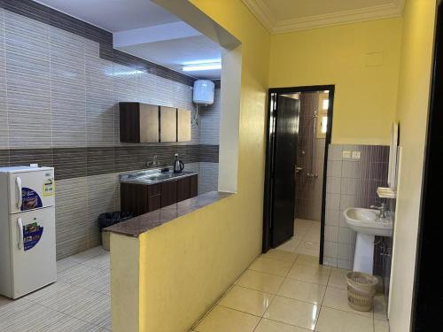 a small kitchen with a sink and a refrigerator at رحيانه ابها in Abha