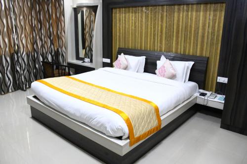 a bedroom with a large bed in a room at Bodhgaya Regency Hotel in Bodh Gaya
