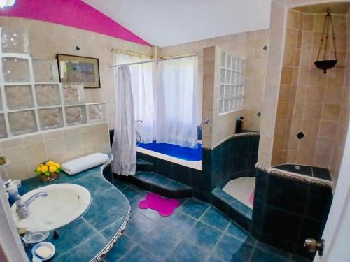 a bathroom with a sink and a shower and a toilet at Rancho Colibrí in Acajutla