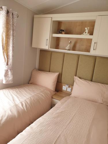 a bedroom with two beds and a cabinet and a window at K7 Annandale in Winthorpe