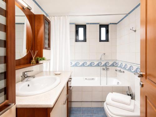 a bathroom with a sink and a tub at Royal Bay Villa Bali in Bali