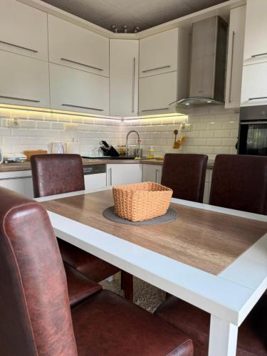 a kitchen with a table with a basket on it at Cerak lux in Bele Vode