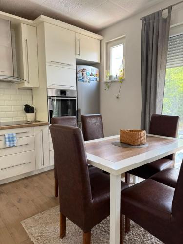 a kitchen and dining room with a table and chairs at Cerak lux in Bele Vode