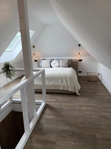a bedroom with a bed in a attic at Pro Home Elia Maisonette in Bad Oeynhausen
