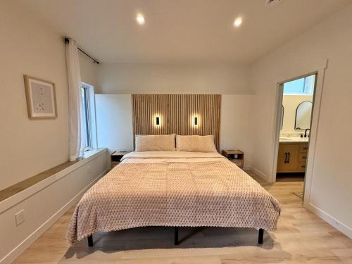 a bedroom with a large bed in a room at Quiet detached home steps from all the action! in Panorama