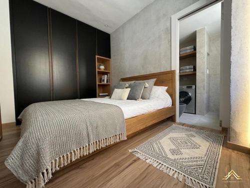 a bedroom with a large bed and a mirror at Urban Waves 1 in Netanya