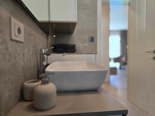 a bathroom with a white sink on a counter at Nautico apartment with swimming pool in Opatija